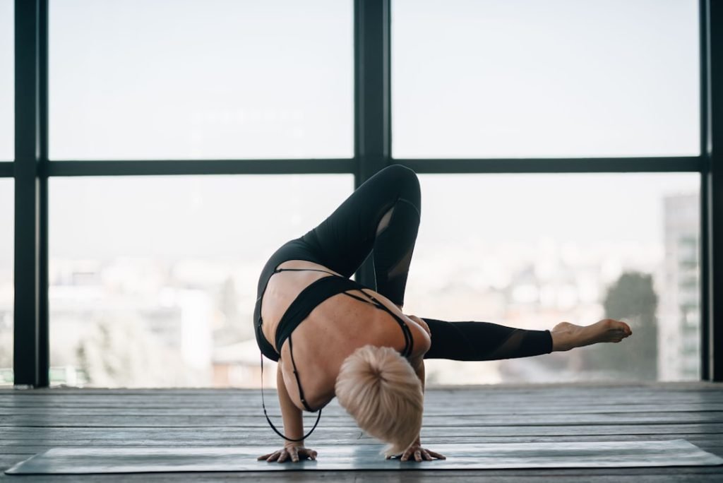 woman-in-black-sports-bra-and-black-leggings-doing-yoga-vv9zlasxfto